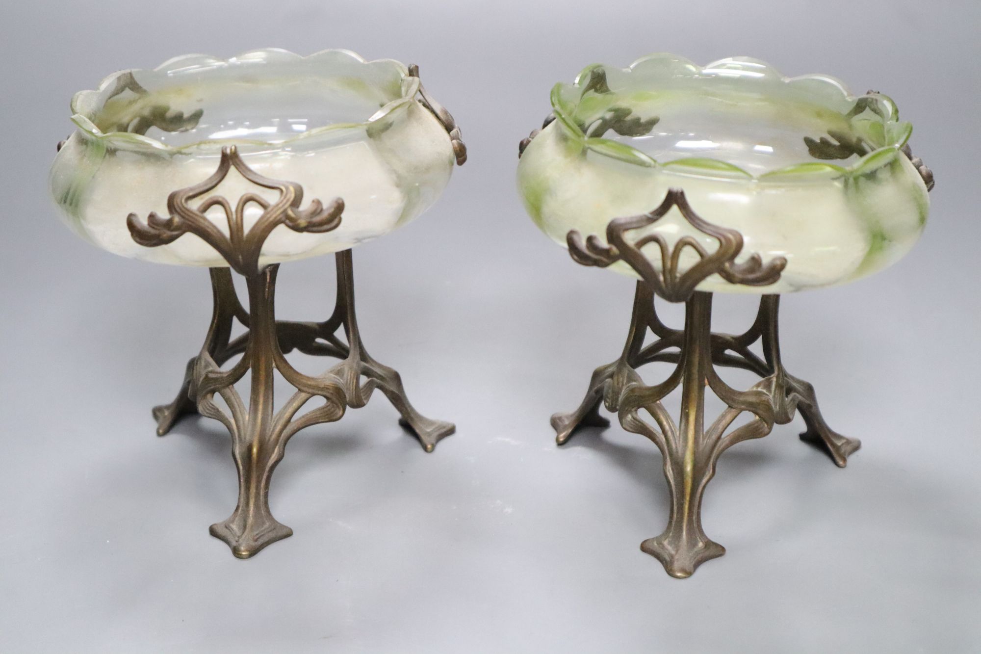 A pair of Art Nouveau vaseline glass dishes, on bronze stands, height 12cm